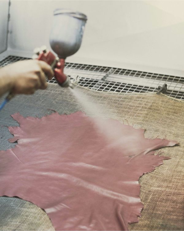 A piece of leather is being tanned by one of our leather artisan.