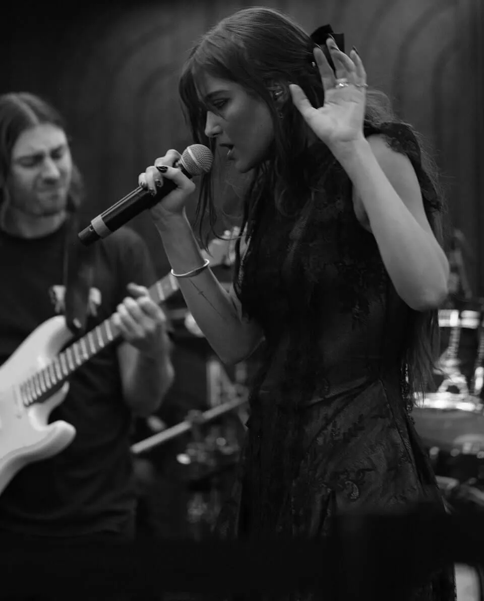 Photo of women singing into microphone