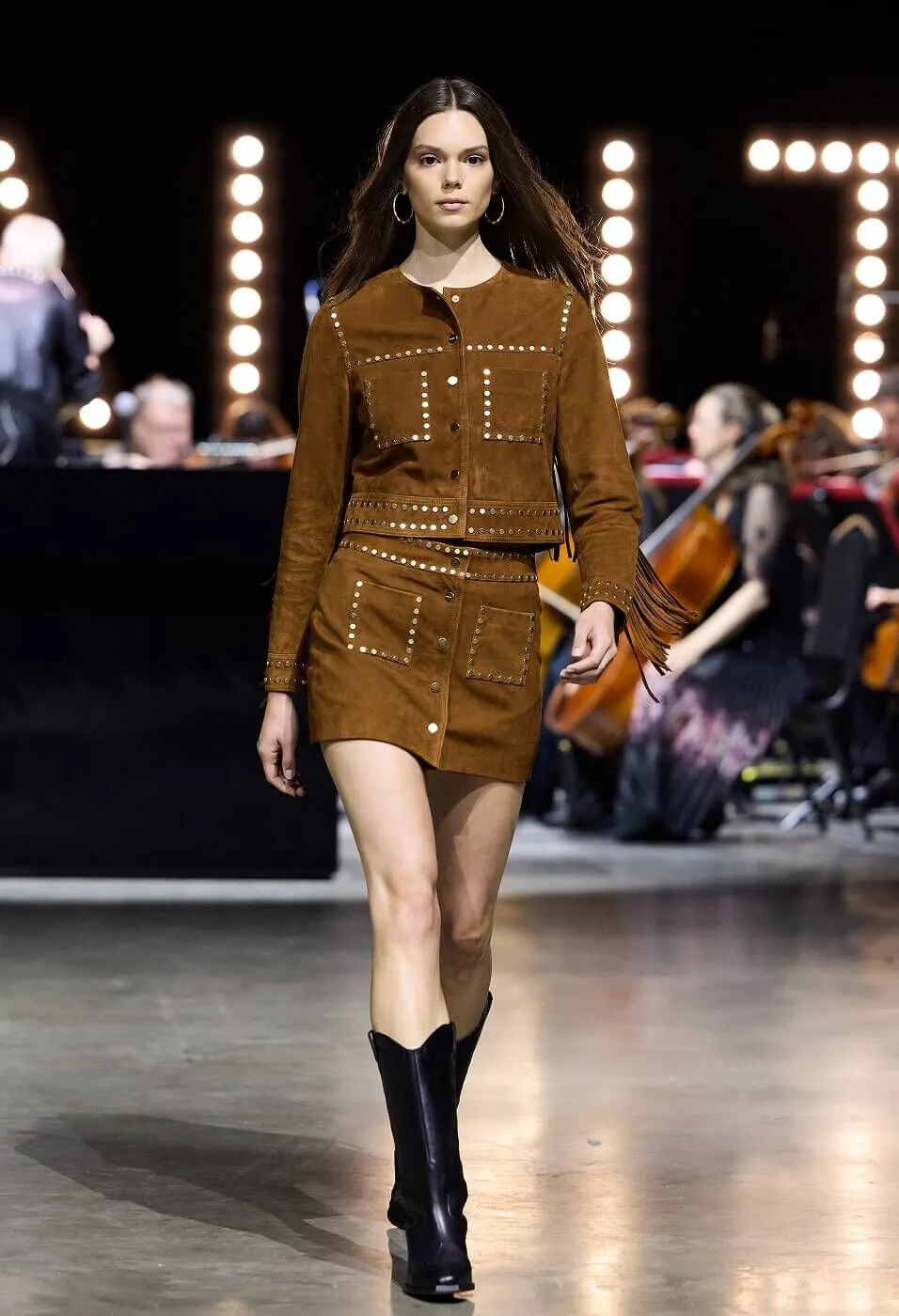 Woman wearing matching studded suede co-ord and black boots