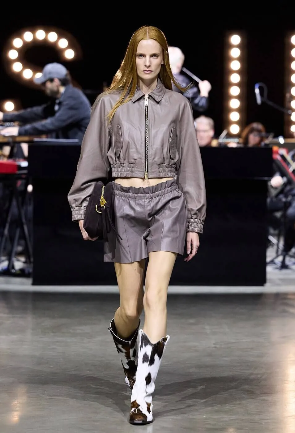 Woman wearing grey leather co-ord with cow hide boots