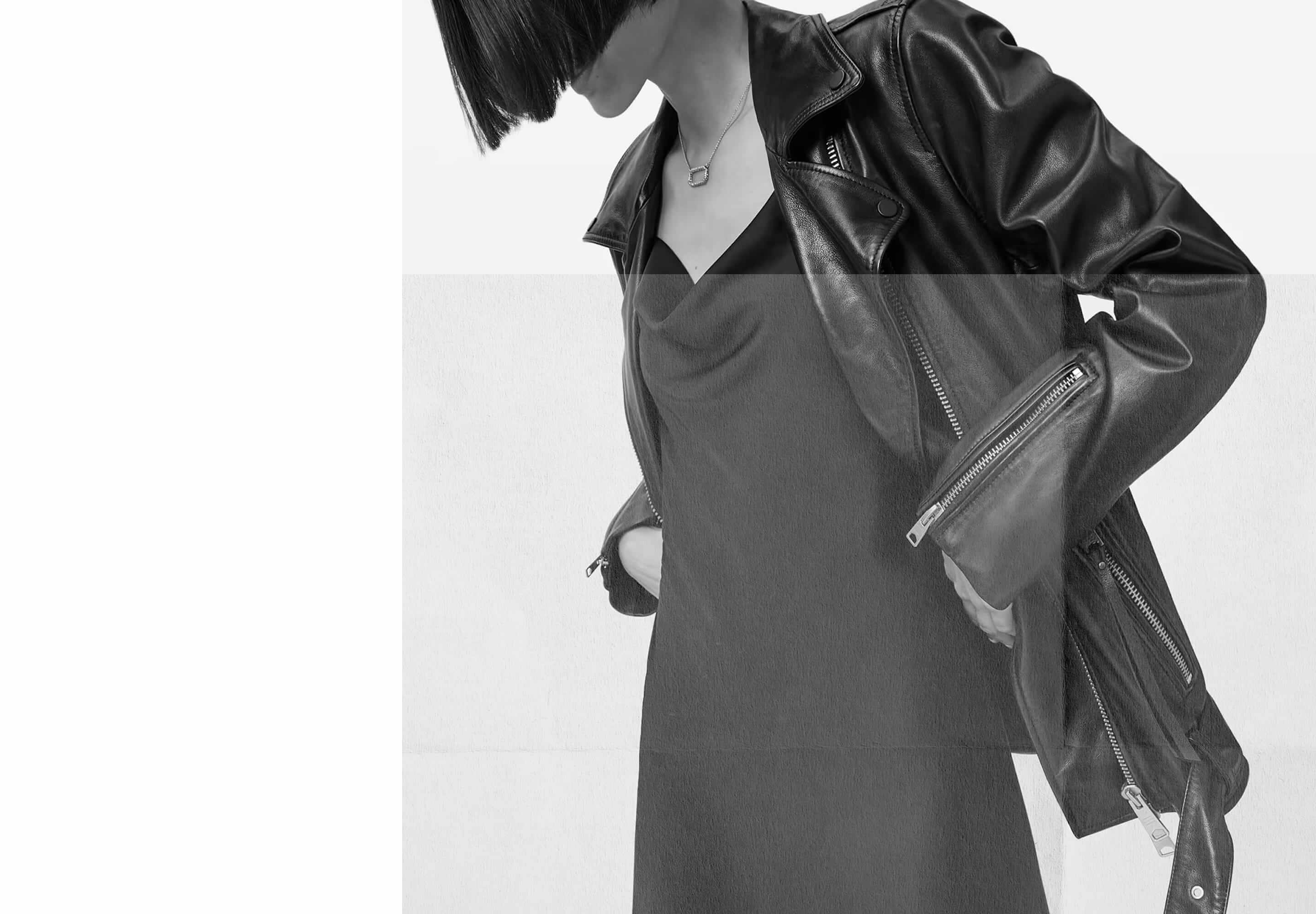person wearing iconic leather jacket over a dress