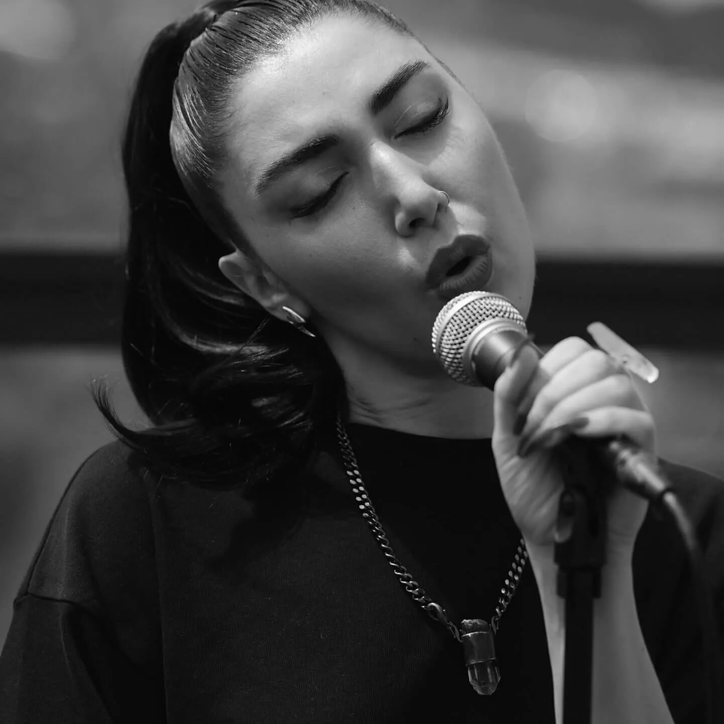 Closeup black and white shot of Storry singing.