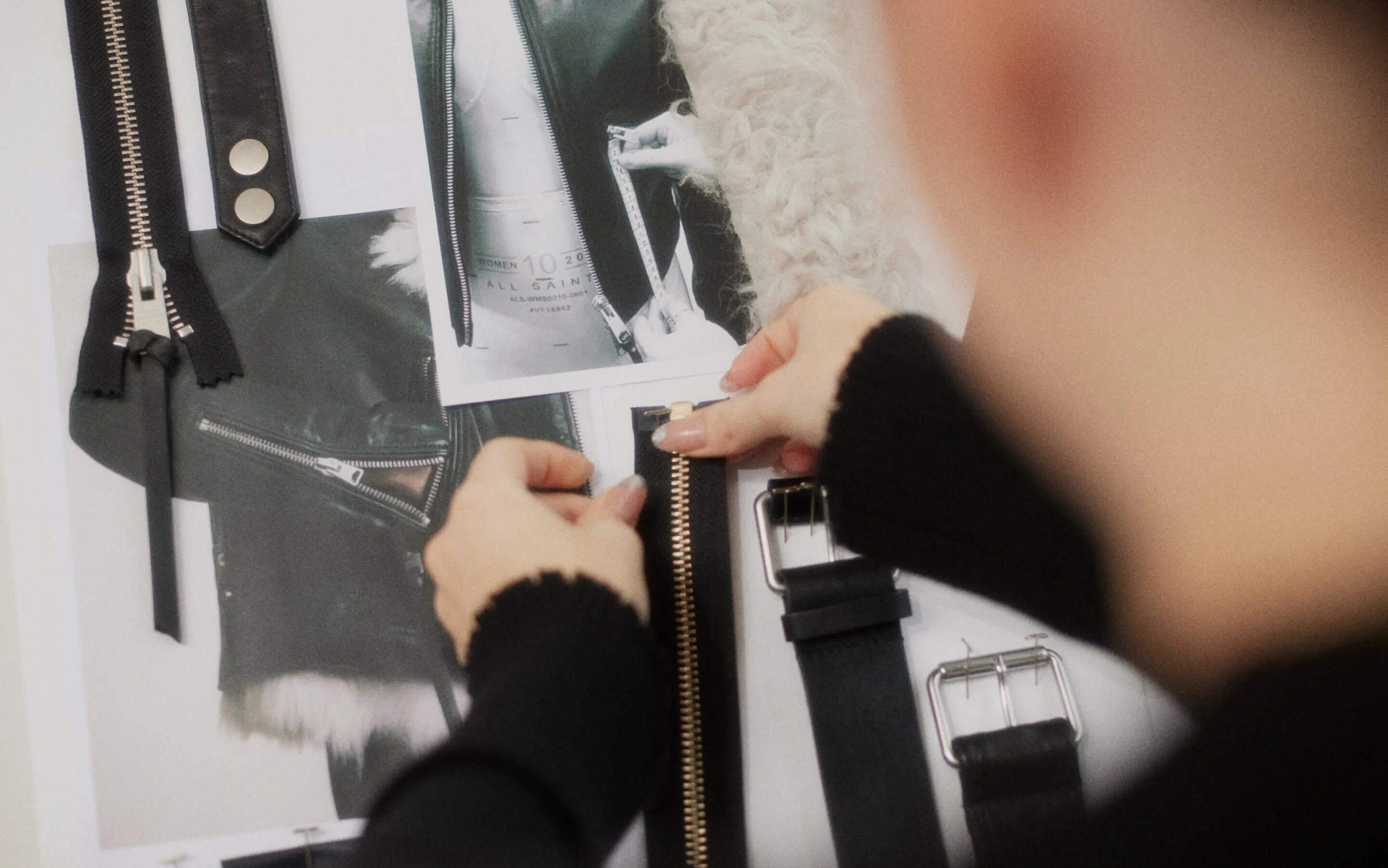 AllSaints employee choosing zips and buckles for one of our leather jackets.