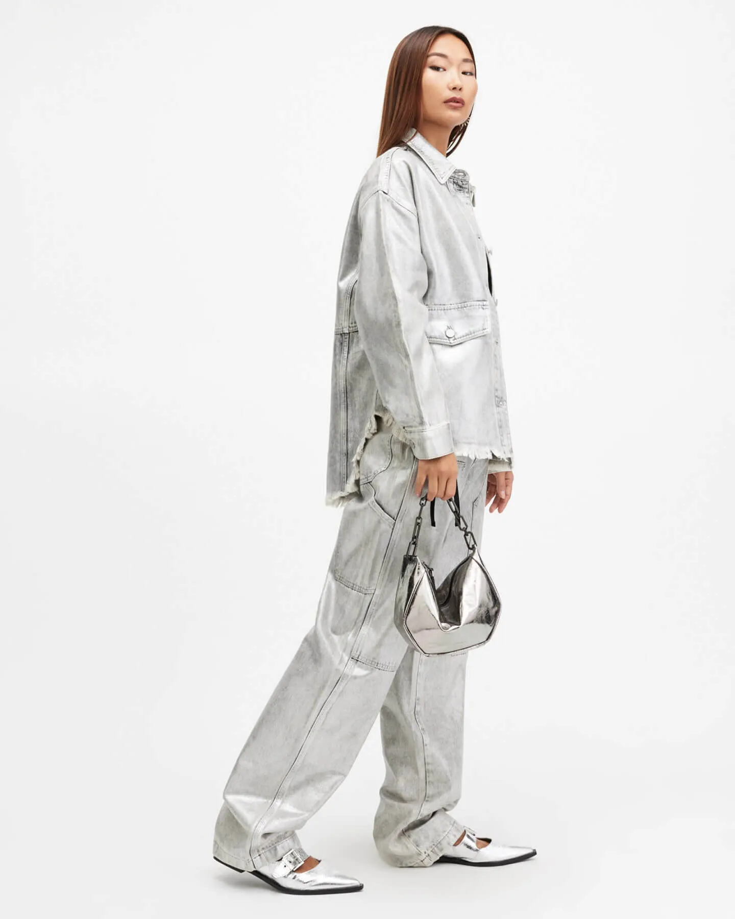 Woman wearing all silver shirt and trousers